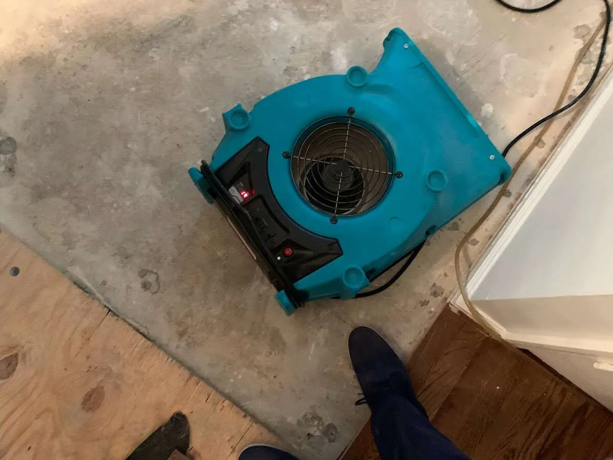 Air mover drying subfloor during Commercial Water Damage Restoration in Hanover